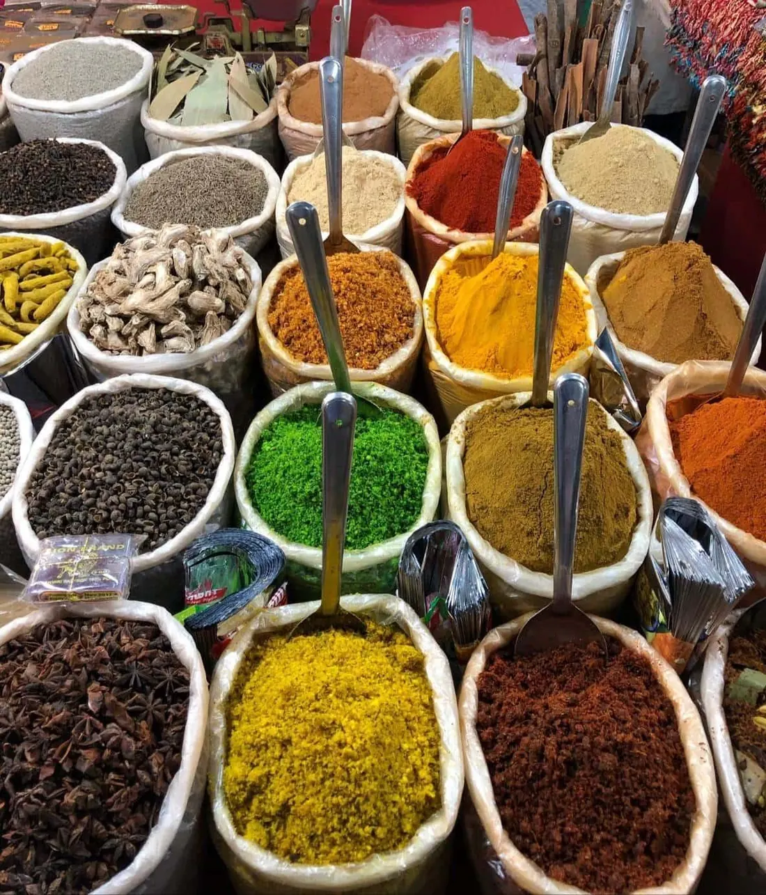 Turmeric, chilli and other ground spices arranged in mounds.